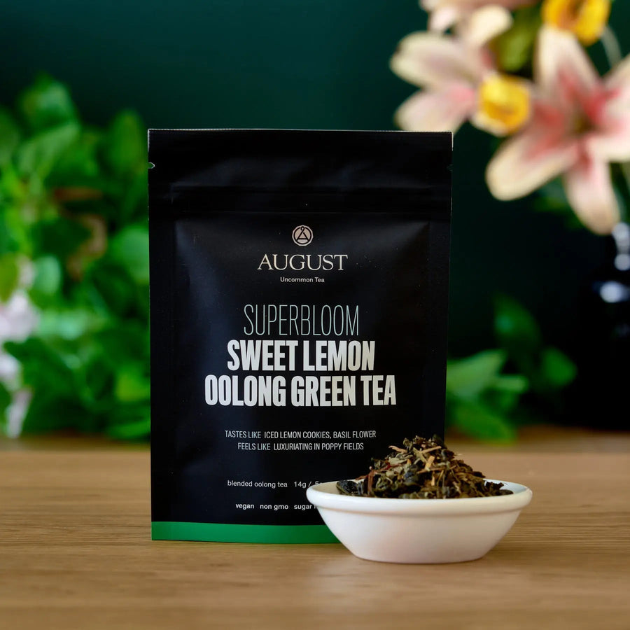 Superbloom Sweet Lemon Oolong Green Tea package styled with a bowl of loose tea leaves