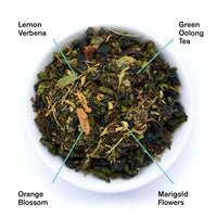 Superbloom loose leaf tea blend in a bowl, labeled lemon verbena, green oolong tea, orange blossom, and marigold flowers