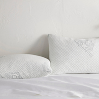 Adjustable bamboo cooling pillow pair styled on a bed